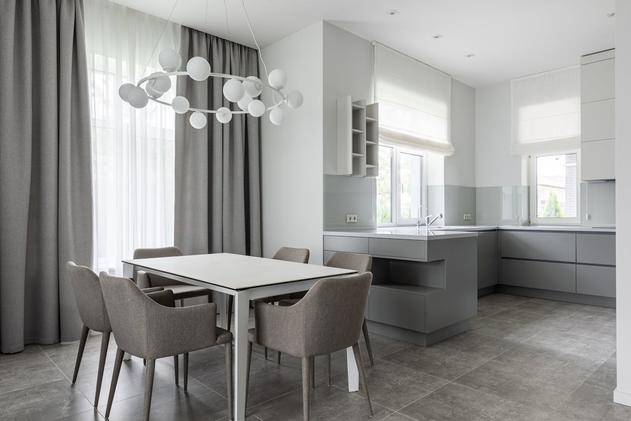 gallery-1 Elegant minimalist kitchen and dining space with neutral tones and contemporary furniture.